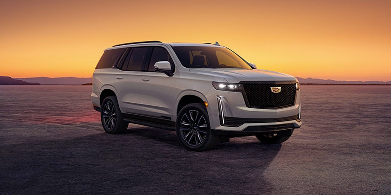 Grey Cadillac Escalade during a sunset
