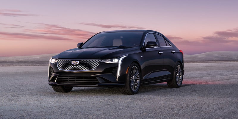 black 2024 cadillac ct4 in front of a sunset